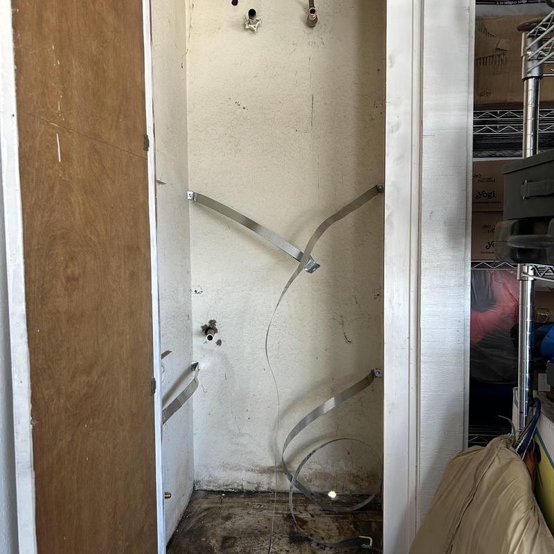 Water heater space with mounting straps installed