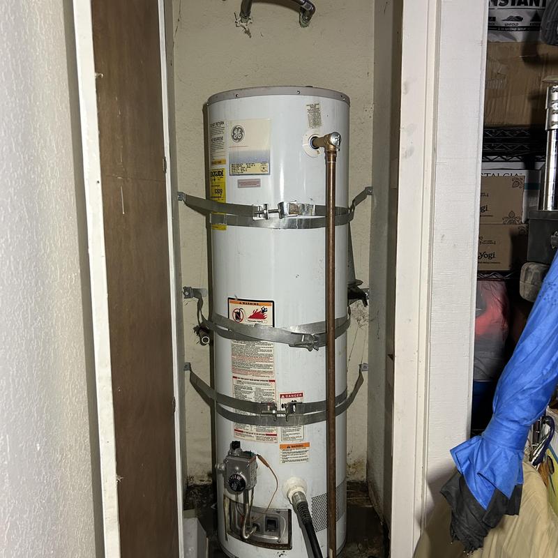 Water heater with seismic straps in utility closet