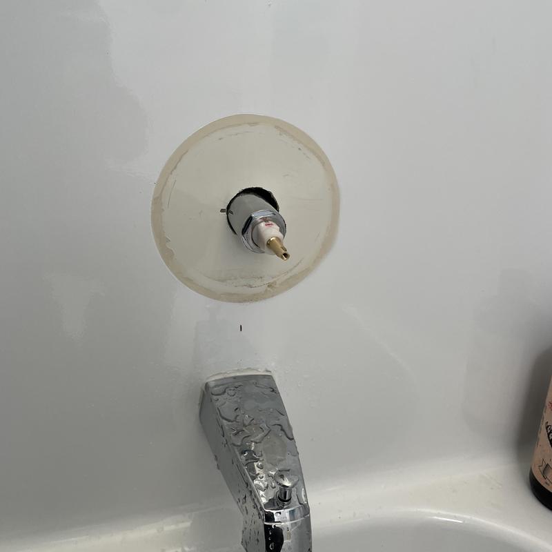 Mixer shower valve cartridge exposed above bathtub faucet