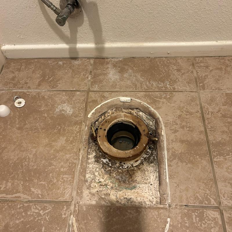 Toilet closet flange on tiled floor removed for repair