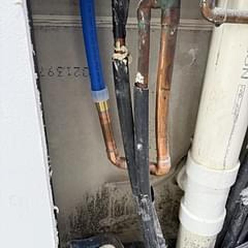 Water heater cold lines capped in wall near pipes