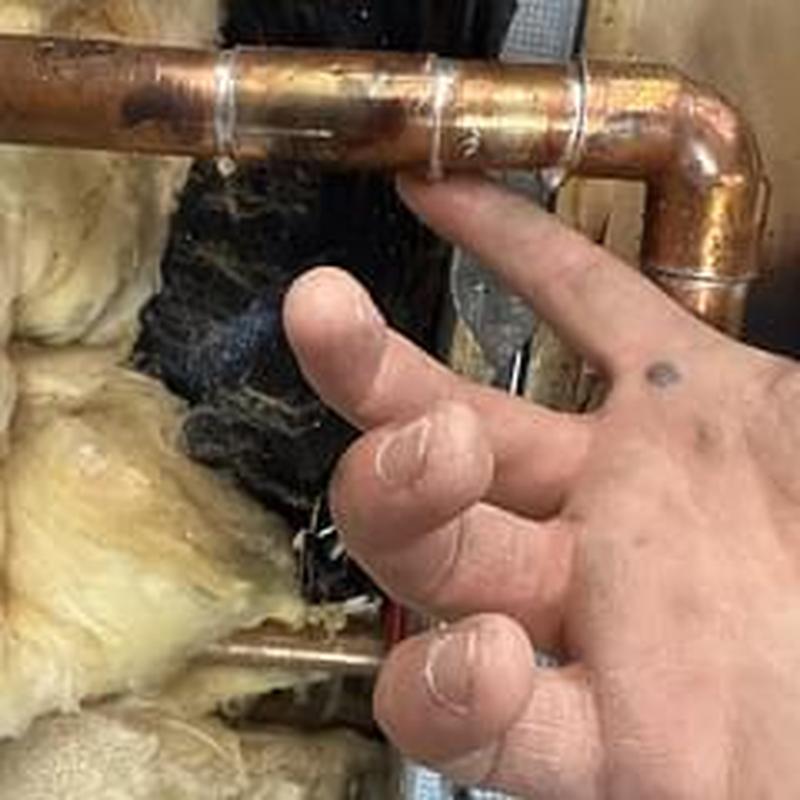 Copper water supply pipe near insulation being inspected