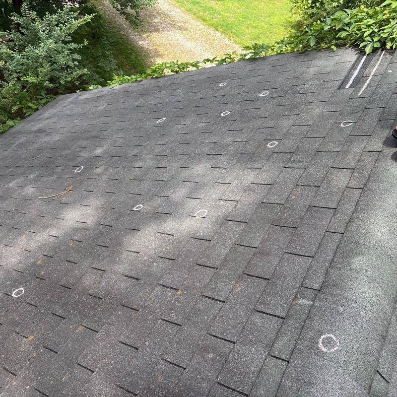 Asphalt shingle roof with storm damage hail marks