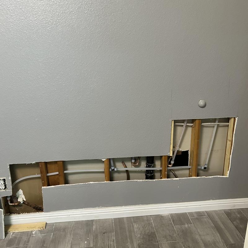 Water line pipes in wall with partial drywall removal