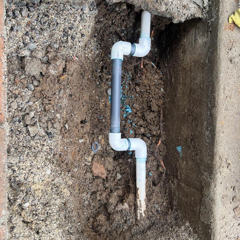 3/4 inch PVC pipe with elbow fittings in dirt trench 3/4 inch PVC pipe with elbow fittings in dirt trench