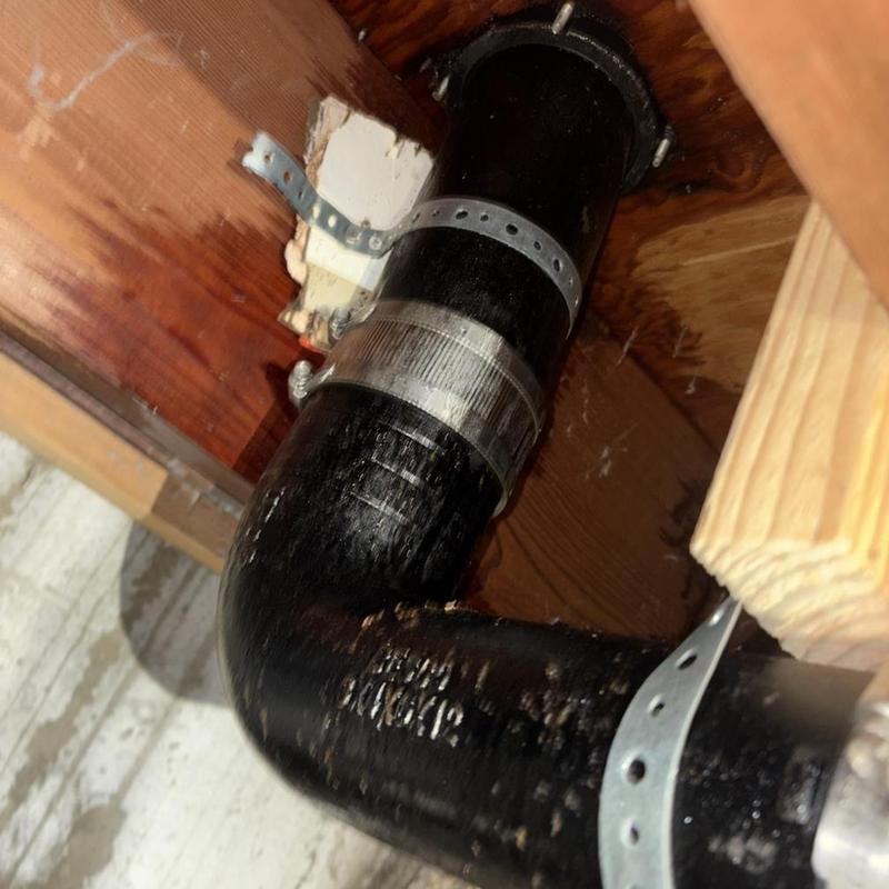 Main sewer line drain pipe with metal clamps installed