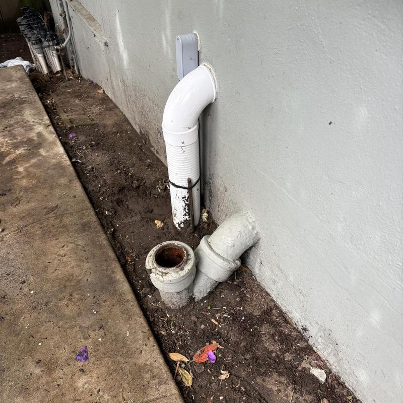 Sewer cleanout and driveway floor drain outside residence