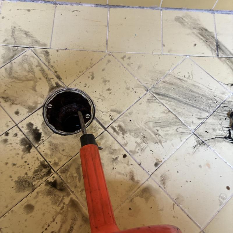 Shower drain cleaning with cabling tool and hair removal