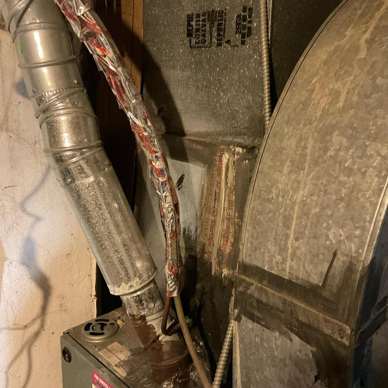 HVAC furnace and ductwork in basement corner