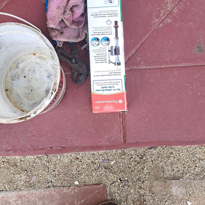 Toilet fill valve box with plumbing tools and bucket