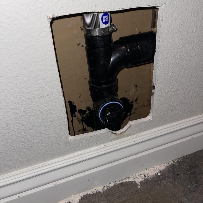 2-inch ABS drain pipe with repair bands in wall cavity