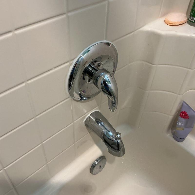 Bathtub faucet and spout with new caulking applied