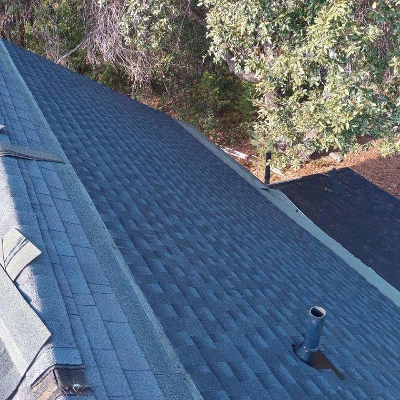 Asphalt shingle roof replacement on cabin with vent pipe