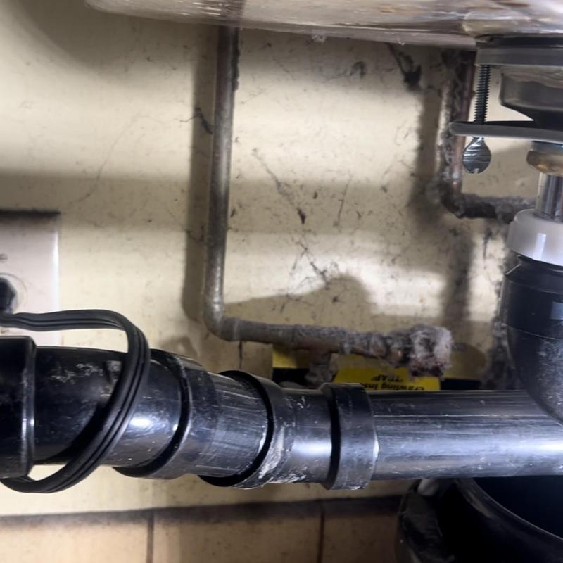 ABS drain pipes under three compartment sink installation