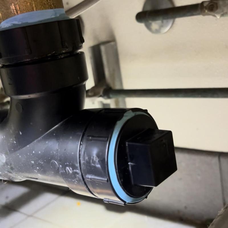 ABS drain pipe with new cleanout installed under sink