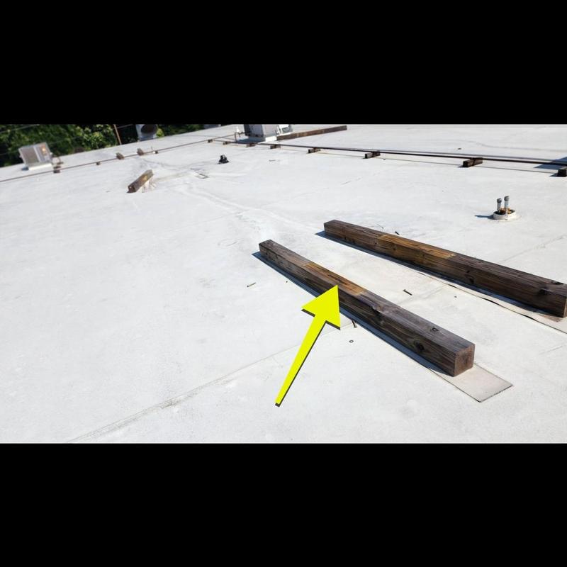 TPO roof with wooden support beams and flashing seams TPO roof with wooden support beams and flashing seams