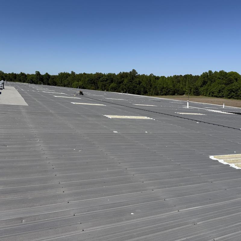 Metal roof with sealed penetrations and clean skylights