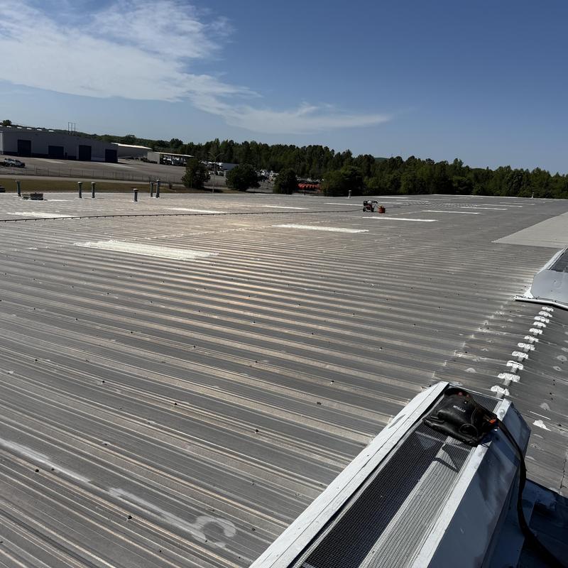 Metal roof with custom ridge cap and sealed fasteners