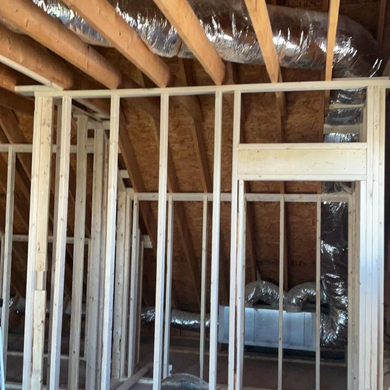 Attic framing and ductwork installation in progress