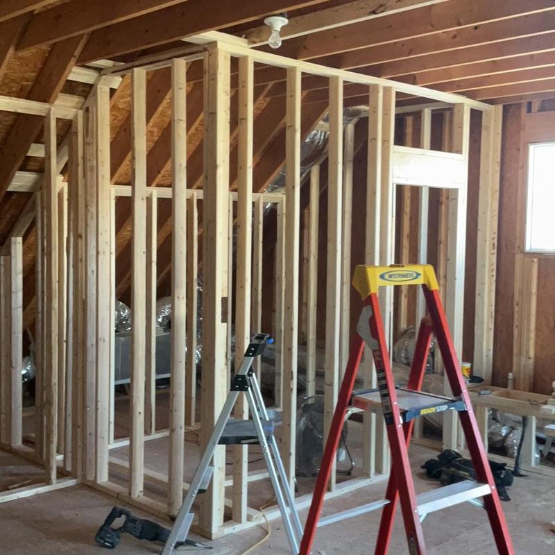 Attic wood framing with ladders and construction tools
