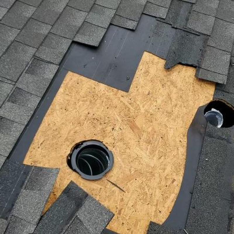 Dryer vent roof opening with black flashing and plywood