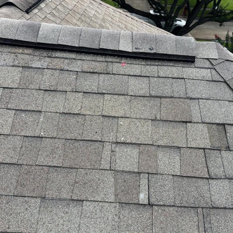 Asphalt shingle roof showing ridge vent installation Asphalt shingle roof showing ridge vent installation