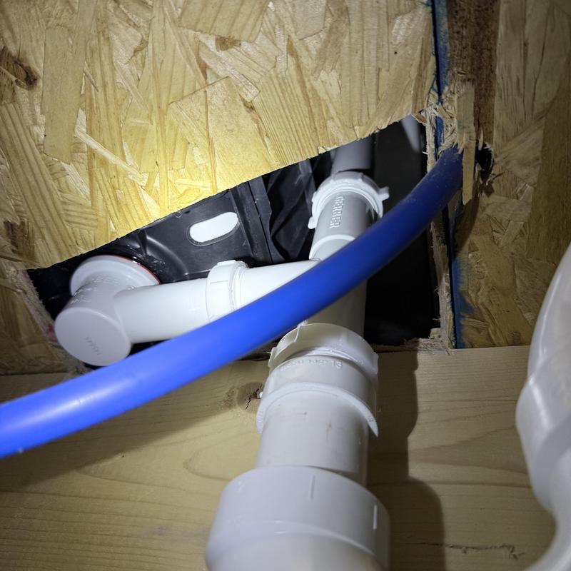 Tub waste PVC piping with blue PEX water line Tub waste PVC piping with blue PEX water line