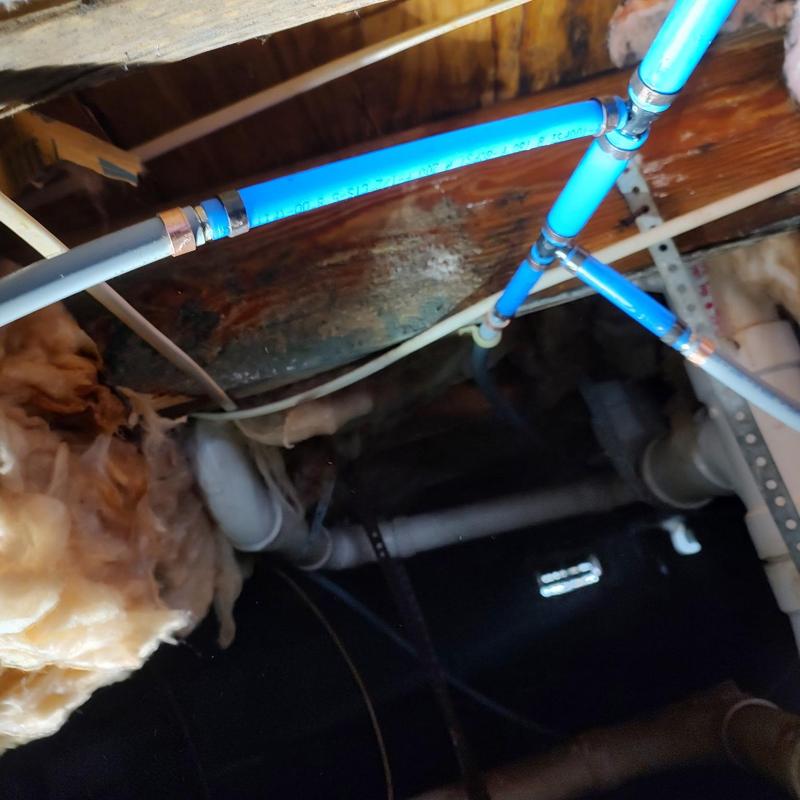 Water line piping in home crawl space with insulation