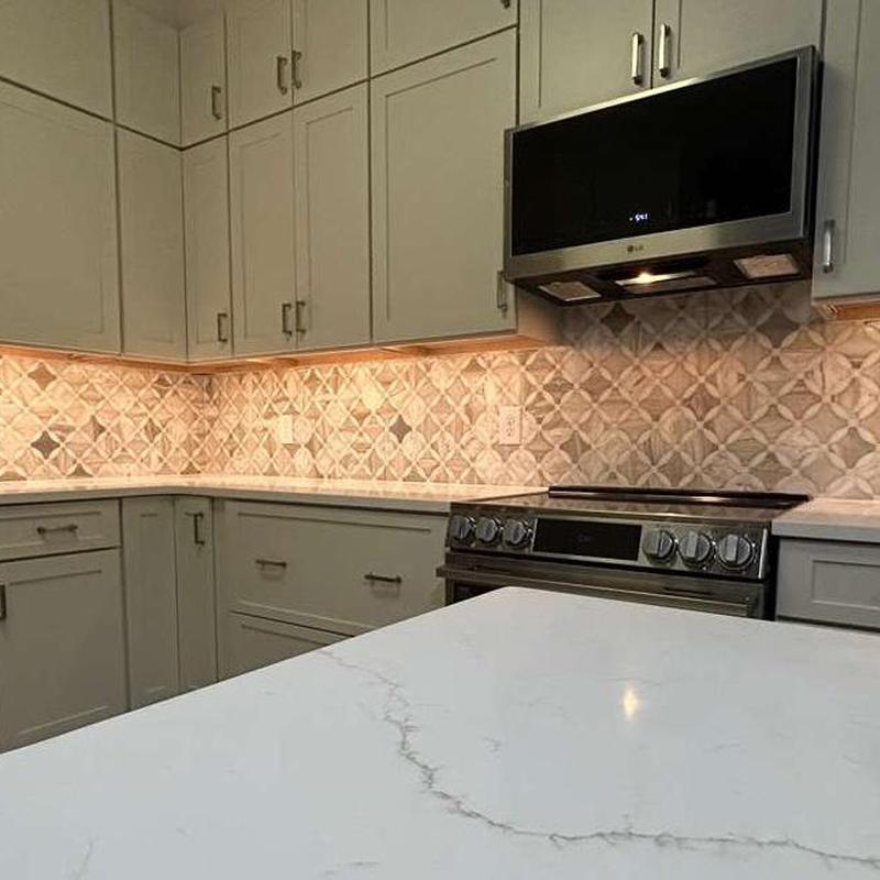 Kitchen countertop with tile backsplash and cabinetry