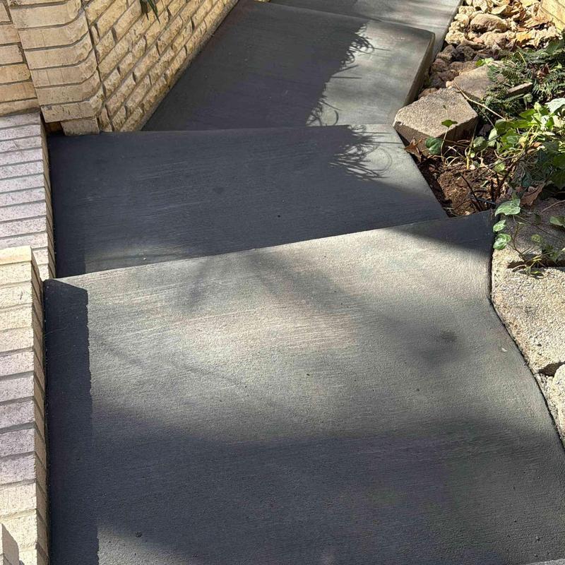 Concrete walkway with steps and adjacent garden bed Concrete walkway with steps and adjacent garden bed