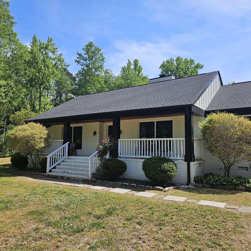 Roof and front porch with railing in home expansion project