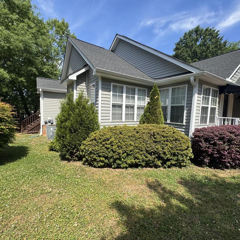 House exterior vinyl siding with shrubs in yard House exterior vinyl siding with shrubs in yard