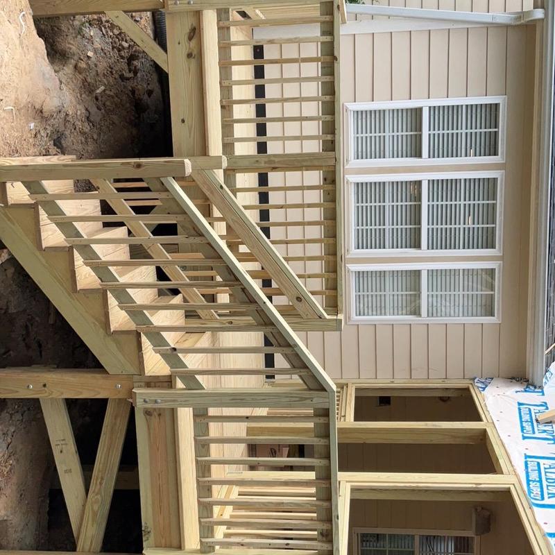 Wooden exterior staircase and deck railing installation