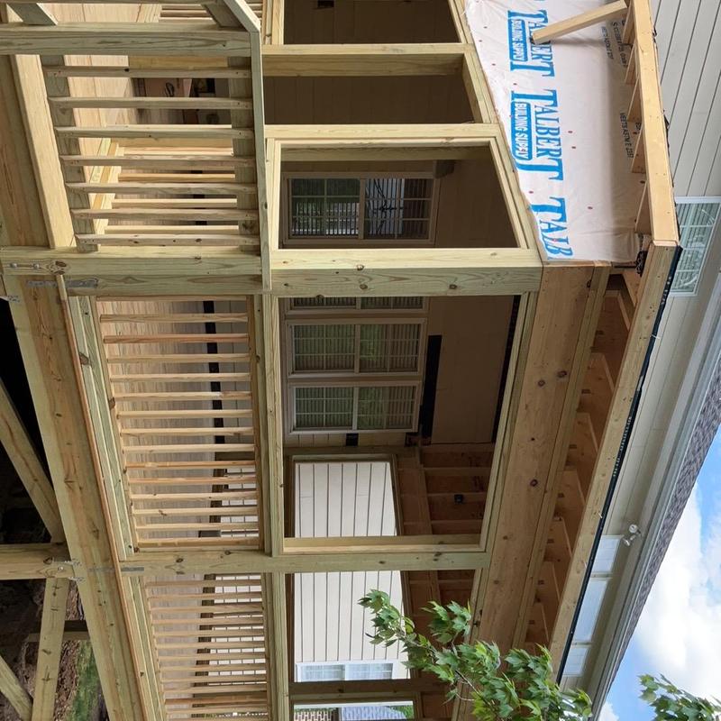 Wooden deck framing and railing installation in progress
