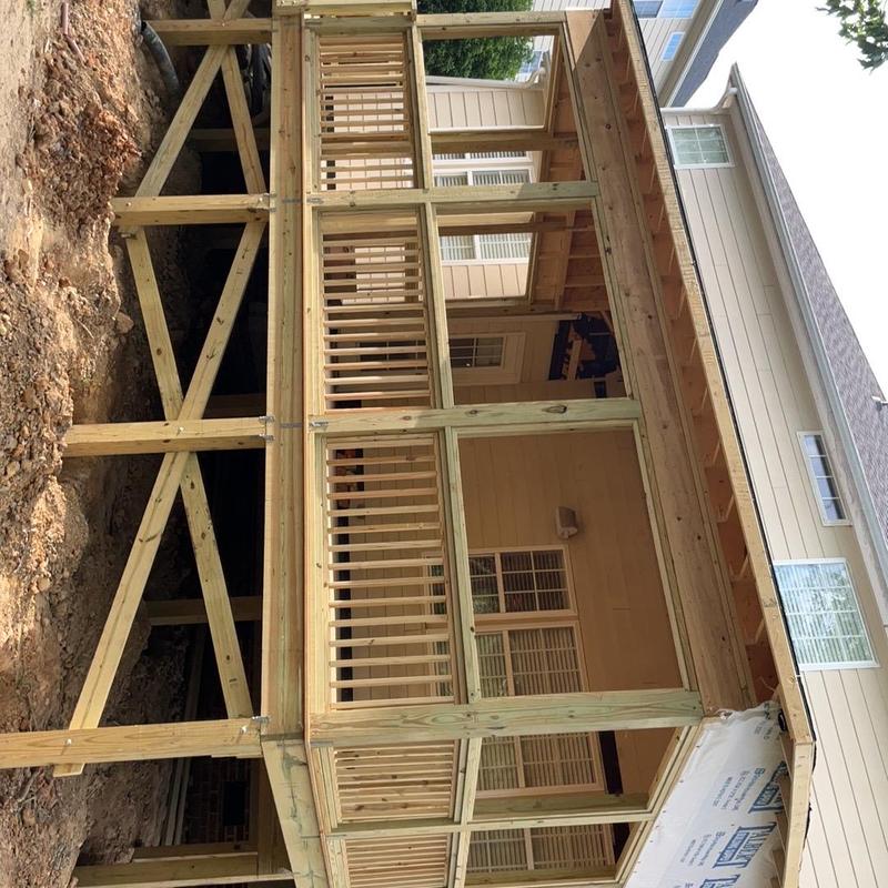 Wooden deck framing and railing under construction