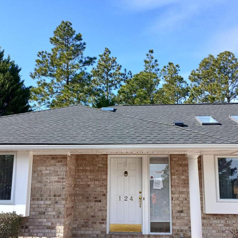 Asphalt shingle roof with skylights on residential home