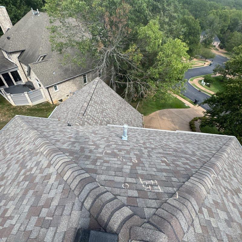Asphalt shingles with hail damage markings on roof