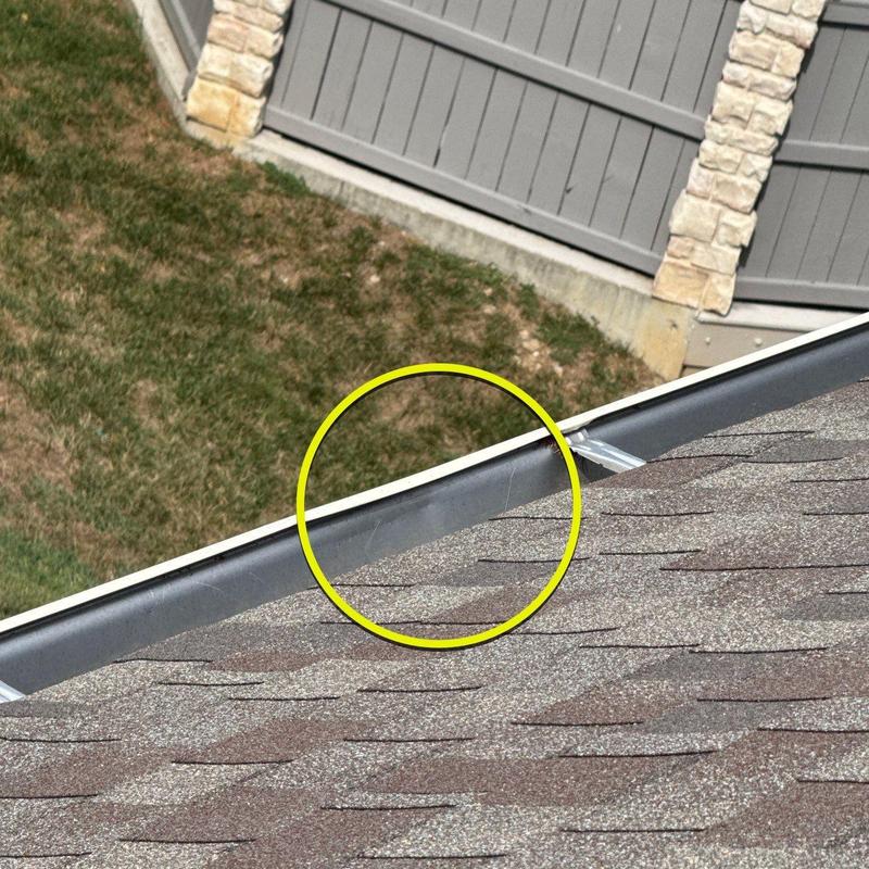 Roof gutter inspection showing damage and wear