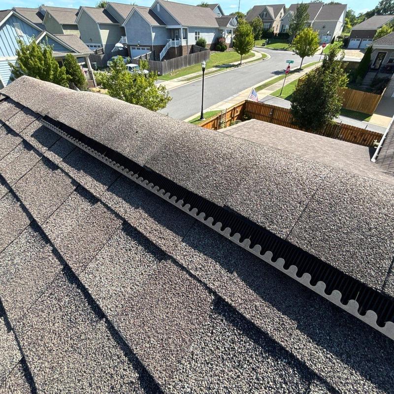 Roof ridge vent installation on asphalt shingle roof