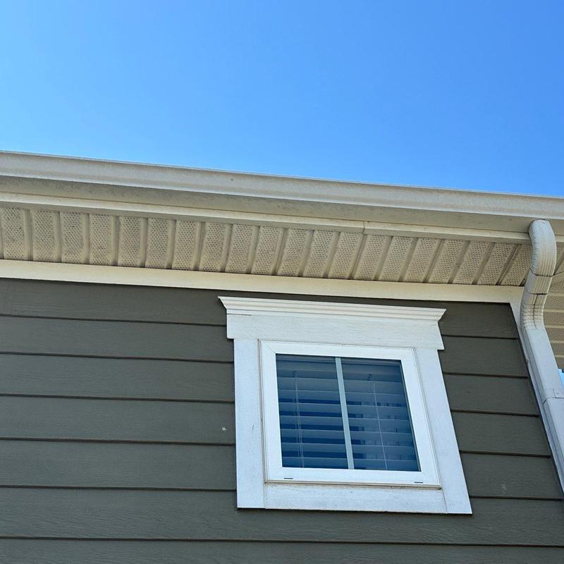 Gutter downspout and siding near window installation