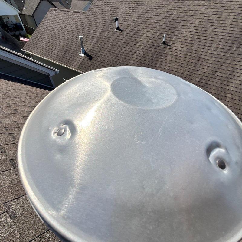 Satellite dish with hail damage dents on roof