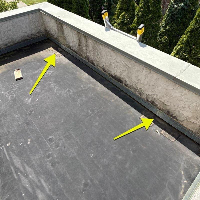 Flat roofing membrane with hail damage and debris