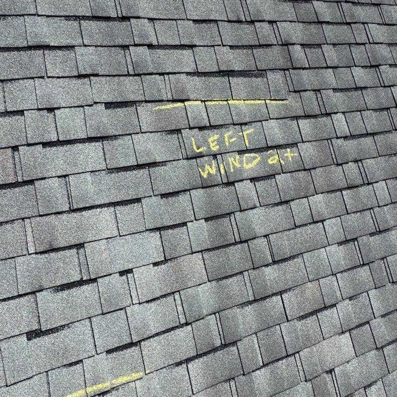 Asphalt shingle roof with hail damage markings