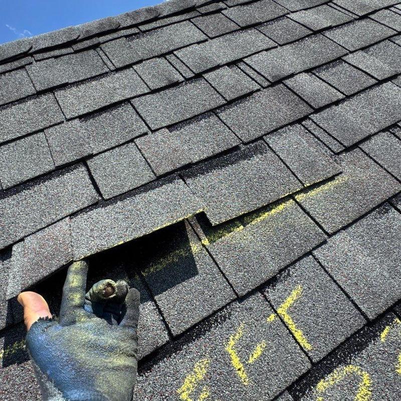 Asphalt shingles with hail damage and inspection markings