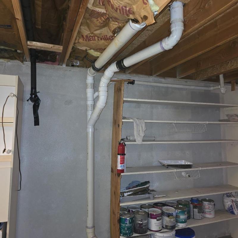 PVC sewer line replacement in basement ceiling junction
