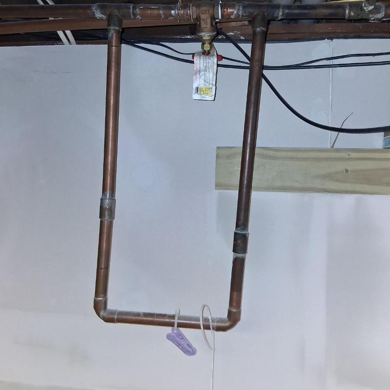 Copper plumbing line with shutoff valve and hanger