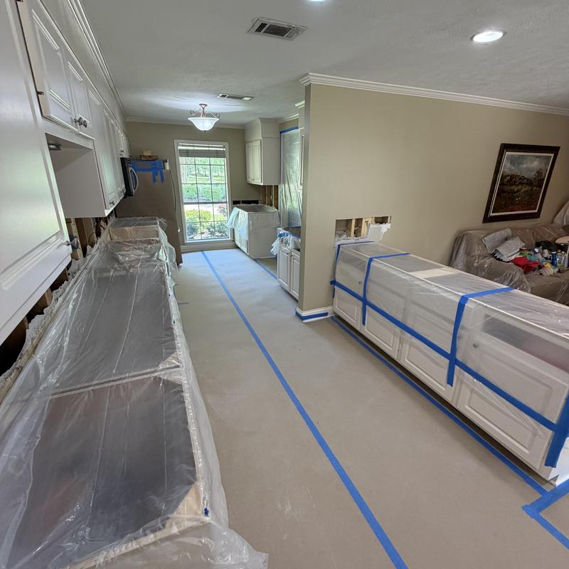 Kitchen countertops and cabinets covered for demo prep