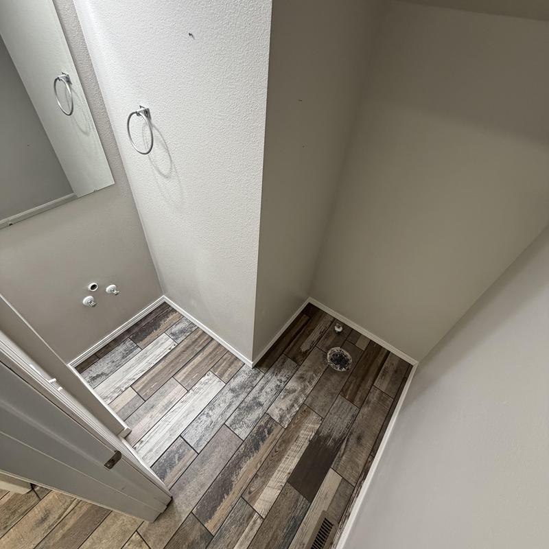 Pedestal sink and toilet plumbing rough-in area