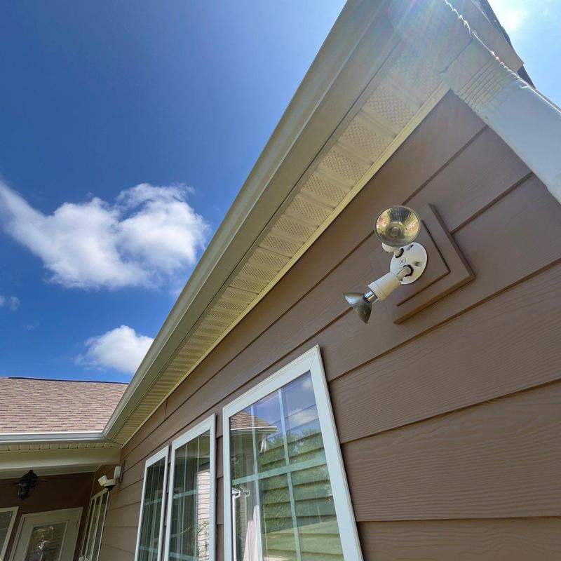 Gutter and soffit with floodlight installation outdoors