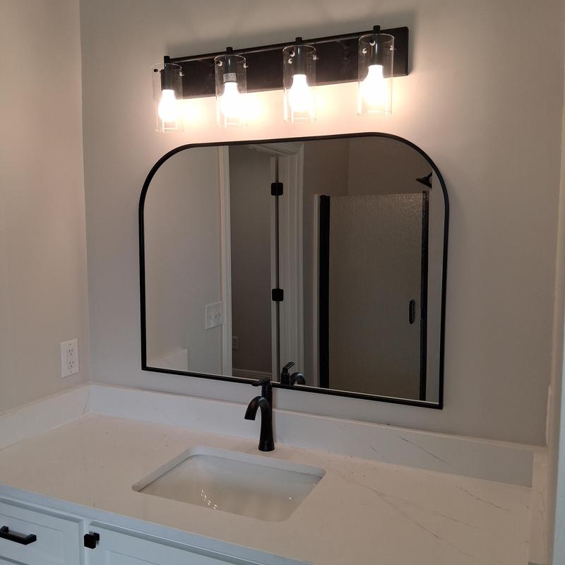 Bathroom mirror with black frame and vanity lighting